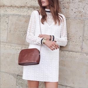 Sezane white crochet dress with black velvet band details.